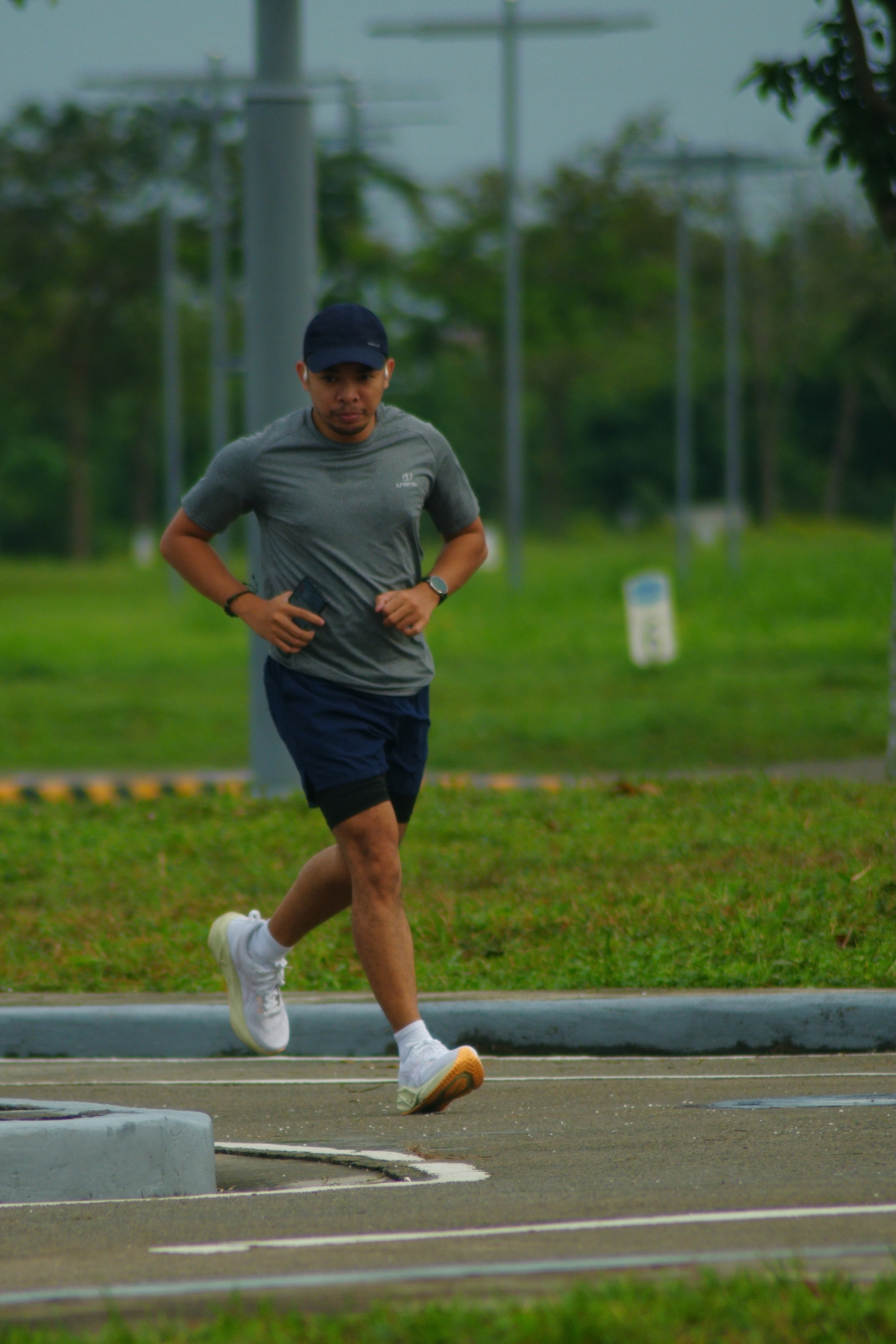 KuyaWen running along a green roadside